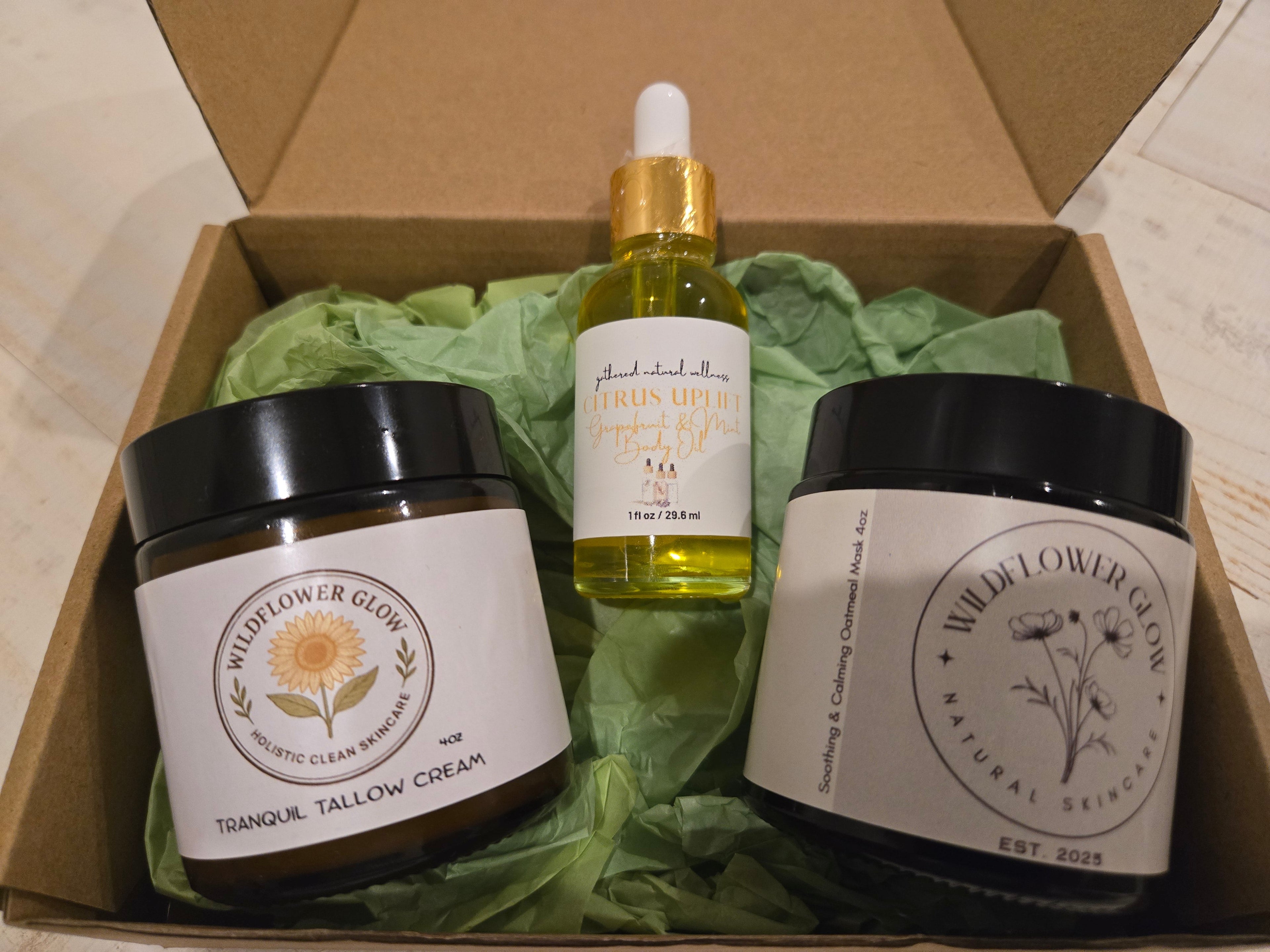 Open box with two moisturizing creams surrounding a citrus body oil.