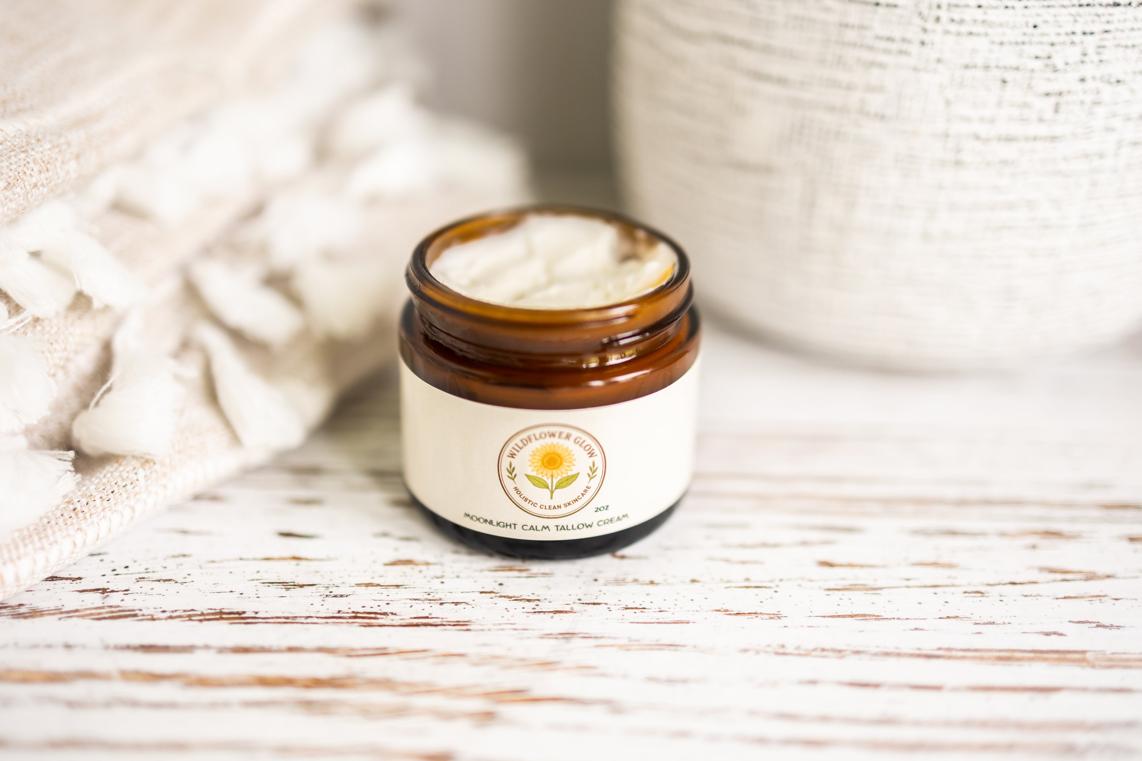 Jar of cream with a visible brand logo on a wooden surface