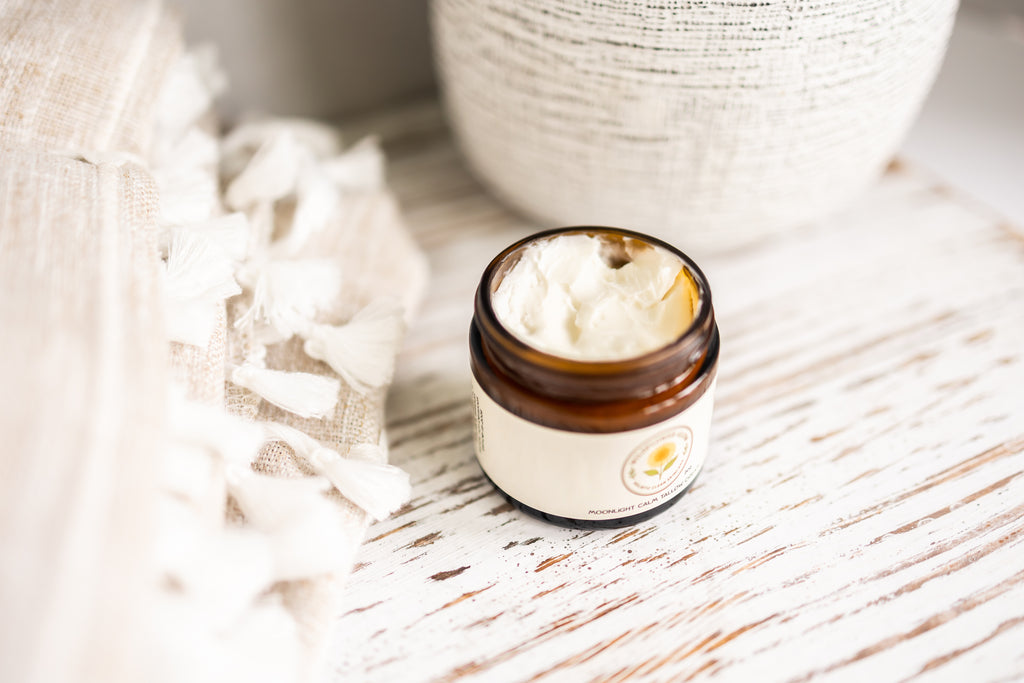 Jar of cream on a wooden surface with a blurred background