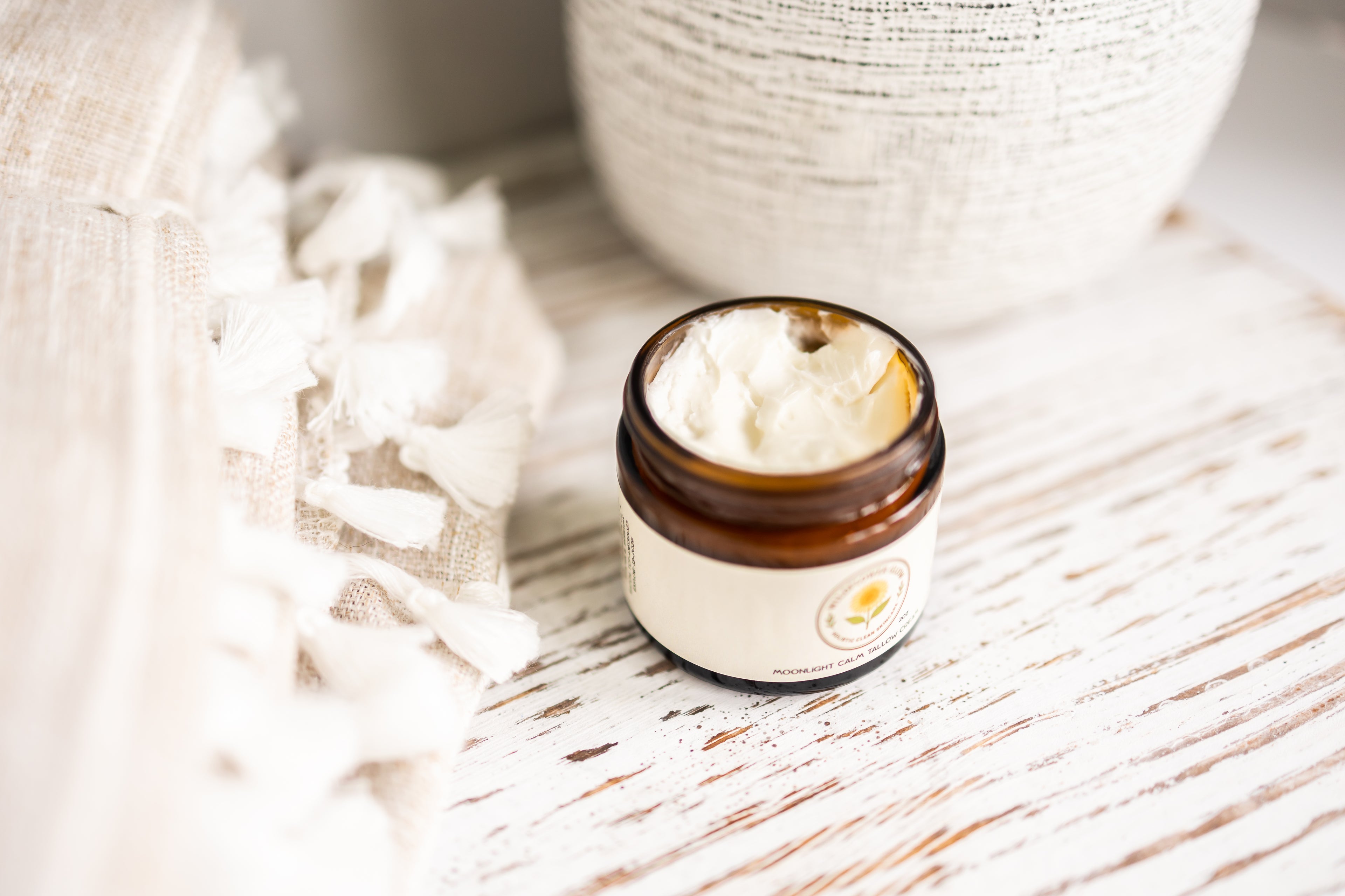 Jar of cream on a wooden surface with a blurred background