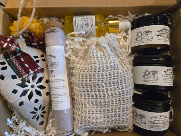 Assorted products including bottles, a bag, and decorative items in a box.