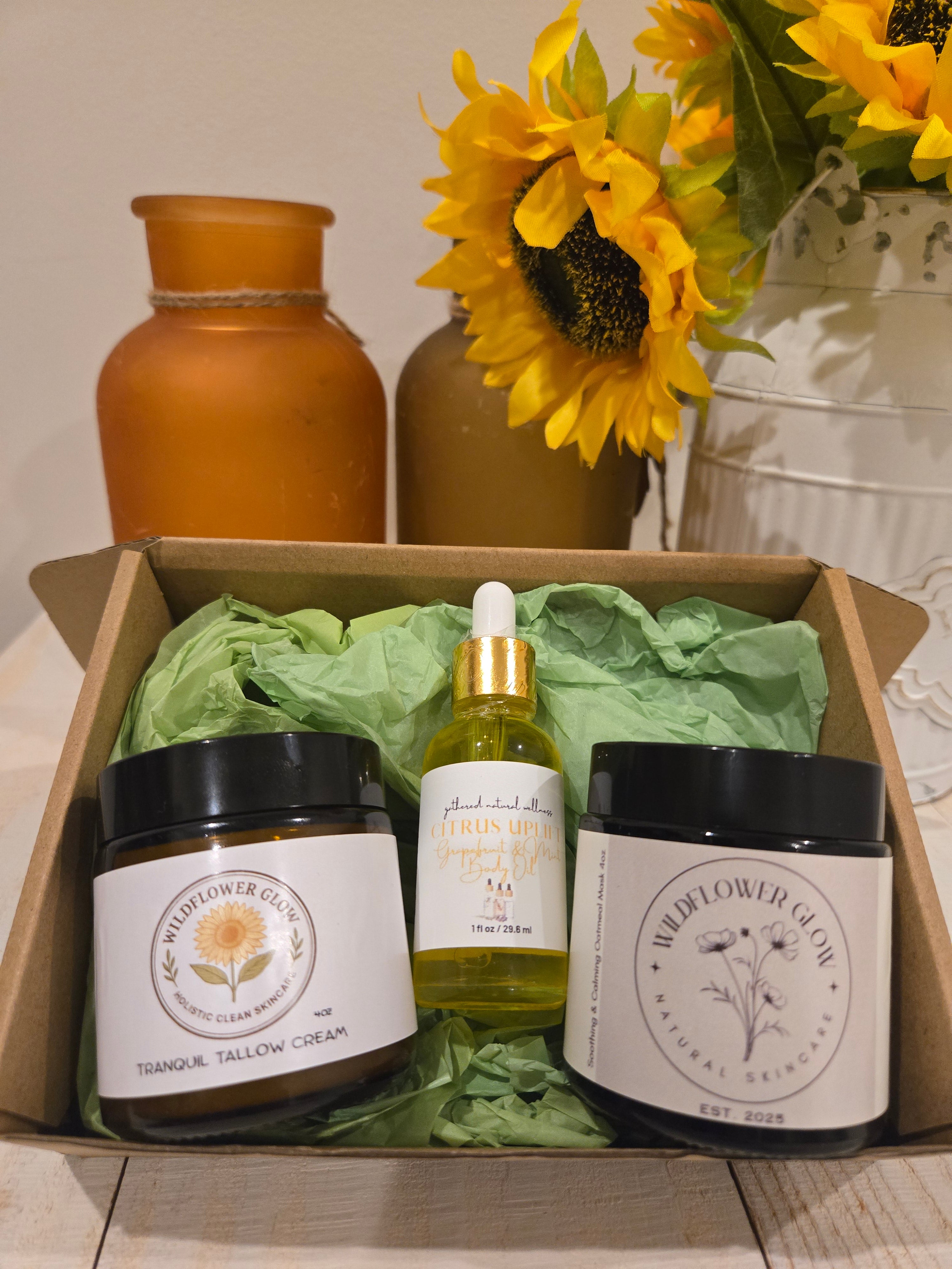 Open box with a moisturizing cream, a bottle of body oil, and a charcoal mask